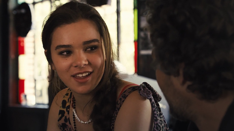Hailee Steinfeld as Violet smiling in a restaurant in Begin Again