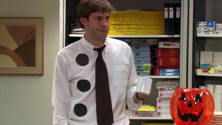 Jim (John Krasinski) dressed as three hole-punch paper on The Office