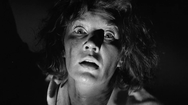Lois Maxwell as Grace Markway in The Haunting, looking tousled and scared and she looks into the camera in close-up.
