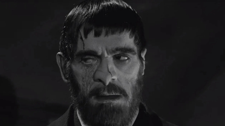 Boris Karloff as Morgan in The Old Dark House, with his scarred and disfigured face as he looks off to his right side.