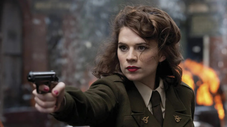 Hayley Atwell as Peggy, aiming a gun in Captain America: The First Avenger