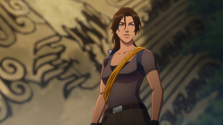 Lara croft stands in front of a tomb in Tomb Raider: The Legend of Lara Croft