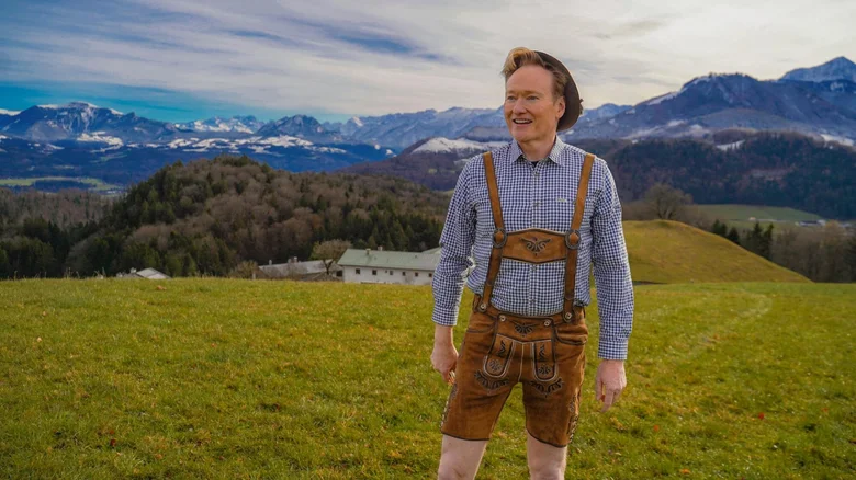 Conan O'Brien dressed in lederhosen in the Austrian Alps in Conan O'Brien Must Go