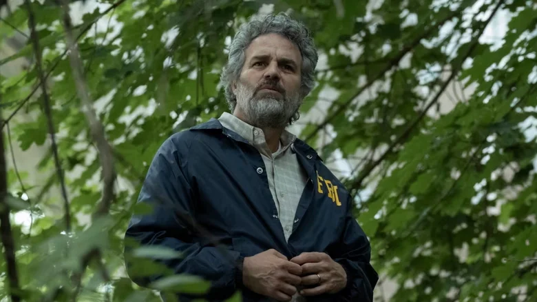 Mark Ruffalo as Tom Brandis standing surrounded by tree branches