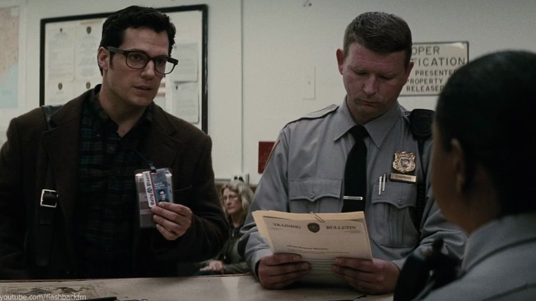 Henry Cavill as Clark Kent showing his press badge at a police station in Batman v Superman: Dawn of Justice (Ultimate Edition)