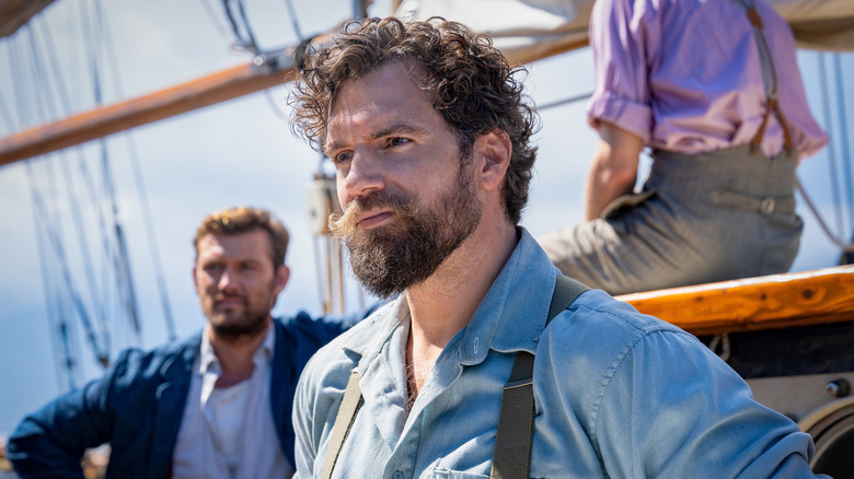Henry Cavill as Gus March-Phillipps standing on a ship with Alex Pettyfer as Geoffrey Appleyard in The Ministry of Ungentlemanly Warfare