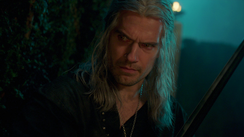 Henry Cavill as Geralt of Rivia wielding a sword in The Witcher