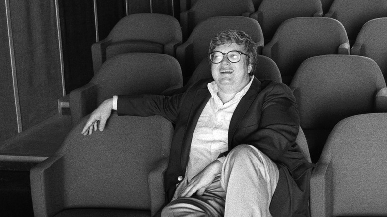 Roger Ebert laughs while sitting in a movie theater in Life Itself (2014)
