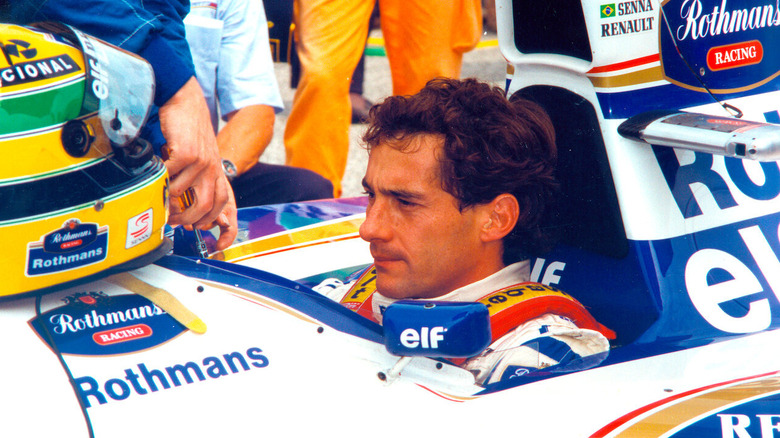 Ayrton Senna sits in his Formula One car looking sternly ahead in Senna (2010)