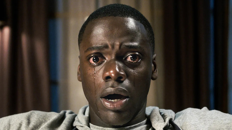 Daniel Kaluuya as Chris Washington, crying in a chair in Get Out.