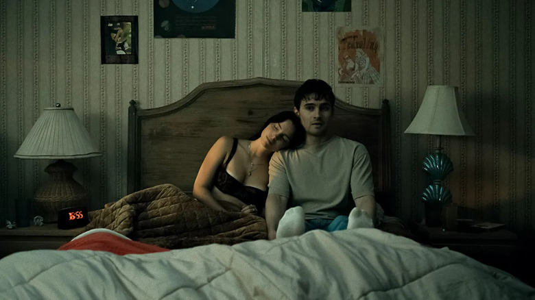 Inde Navarrette as Nikki Freeman and Michael Johnston as Bear, sitting on his bed in Obsession.