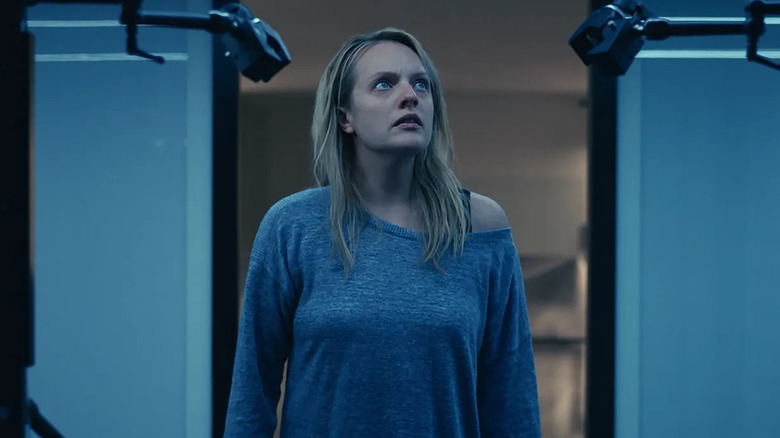 Elisabeth Moss as Cecilia Kass, looking at an invisible suit in The Invisible Man.