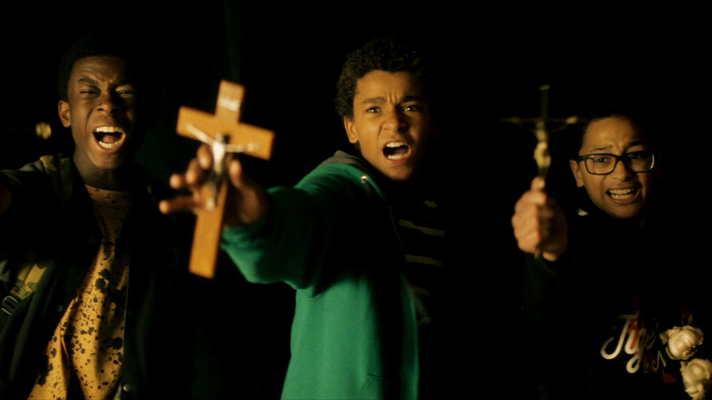 Miguel, Bobby, and Luis defend themselves with crucifixes in Vampires Vs. The Bronx