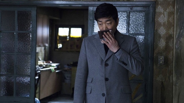 Son Hyeon-ju as Seong-soo, trying to block a smell in Hide and Seek