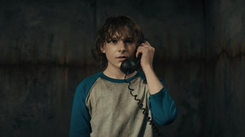 Finney Blake (Mason Thames) answers a black phone in The Black Phone