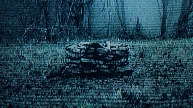The famous shot of the isolated well in The Ring, with Daveigh Chase as Samara Morgan beginning to climb out of it.