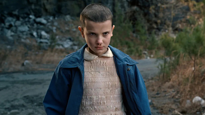 Millie Bobby Brown as Eleven, glowering with a bloody nose in Stranger Things.