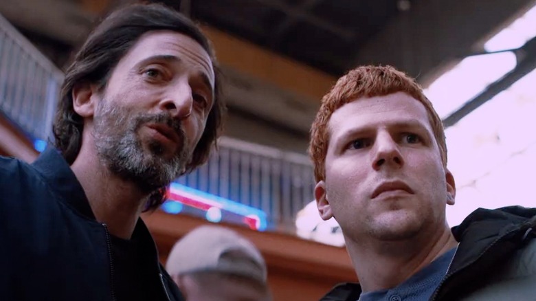 Adrian Brody as Dan and Jesse Eisenberg as Ralphie looking outward during a conversation in Manodrome