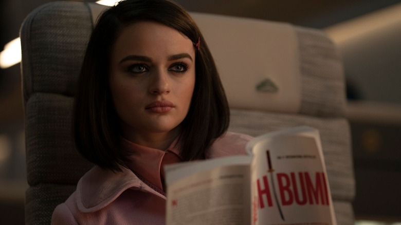 Joey King as the prince, reading a book on a train in Bullet Train