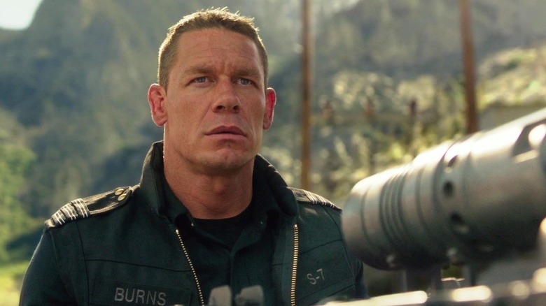 John Cena as Agent Jack Burns manning a heavy gun on a vehicle in Bumblebee