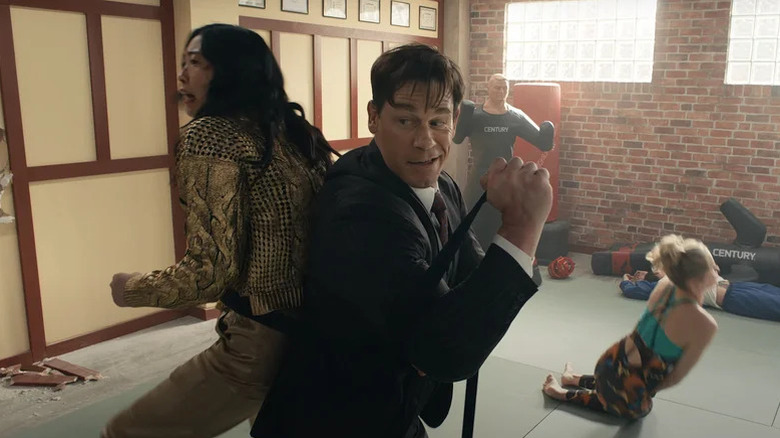 Awkwafina and John Cena as Katie and Noel fighting back-to-back in Jackpot