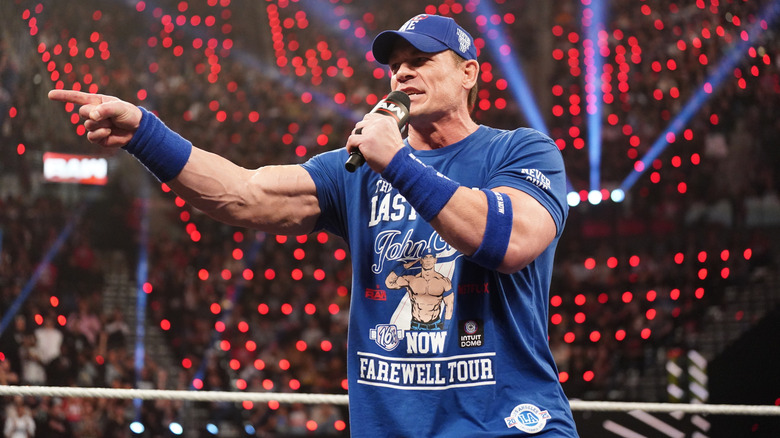 John Cena speaking into a microphone in the ring on WWE Raw