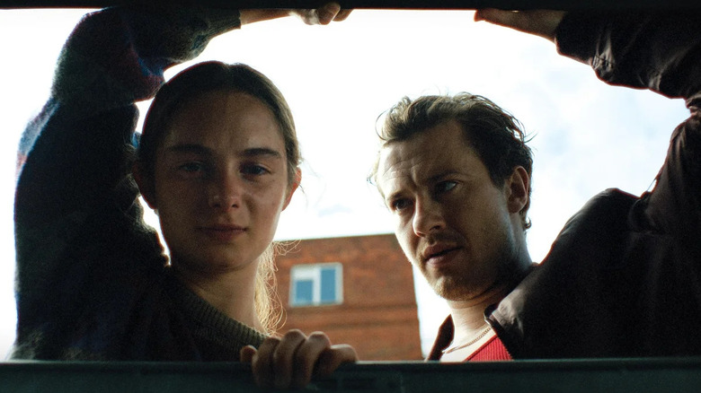 Saura Lightfoot Leon and Joseph Quinn as Maria and Michael, looking down in Hoard