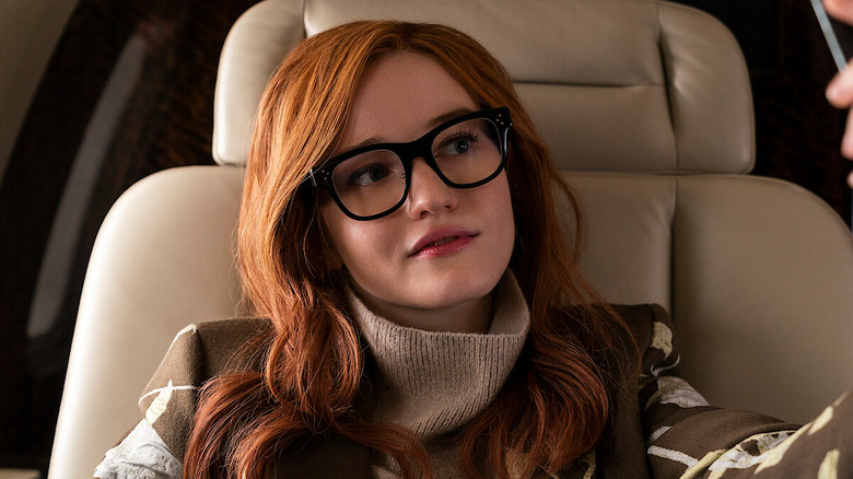 Julia Garner as Anna Delvey, taking a selfie in Inventing Anna