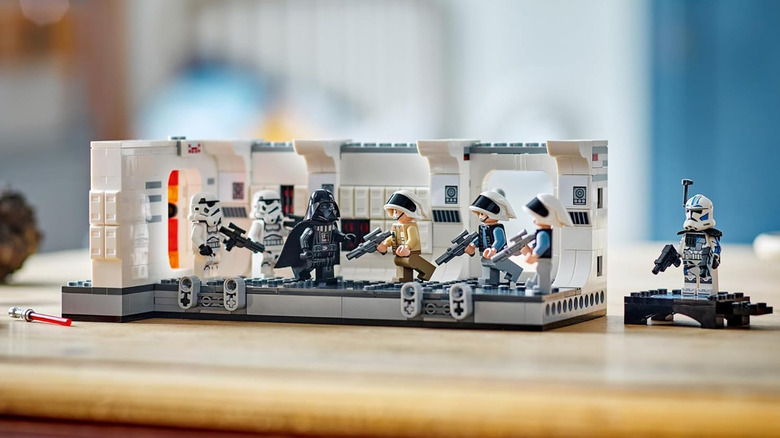 A LEGO model of Darth Vader and Stormtroopers fighting rebels