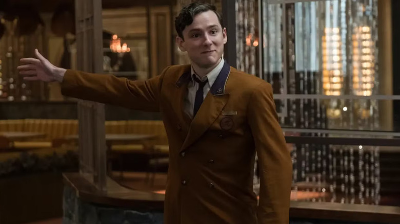 Lewis Pullman as Miles Miller, directing people toward a location in Bad Times at the El Royale