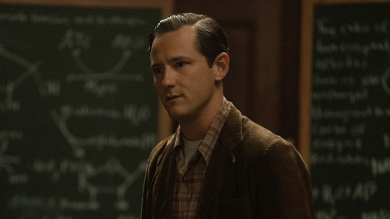 Lewis Pullman as Calvin standing in a classroom in Lessons in Chemistry