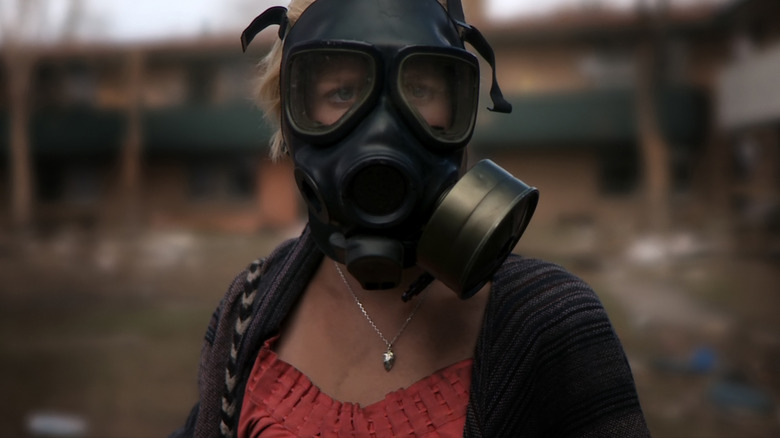 Whitney Able as Sam Wynden in Monsters, wearing a gas mask.