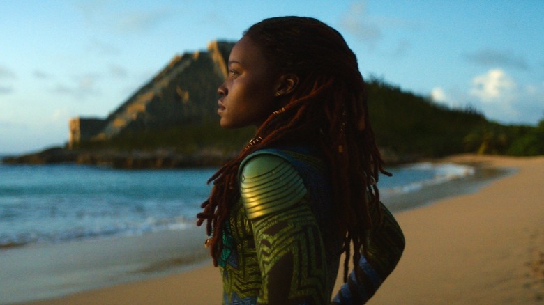 Nakia (Lupita Nyong'o) surveys the ocean from a beach in Black Panther: Wakanda Forever