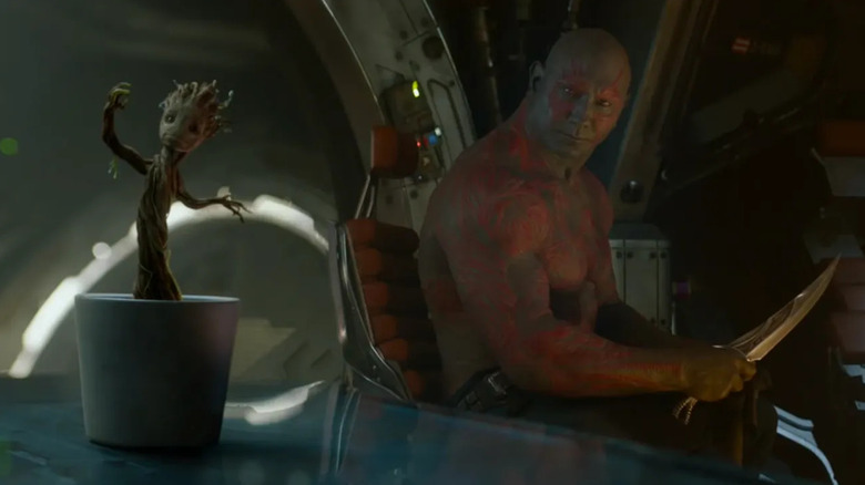 Drax (Dave Bautista) glares at a potted baby Groot in Guardians of the Galaxy