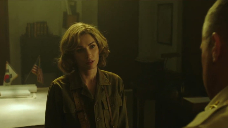 Blonde Megan Fox as Maggie standing in front of Colonel Stephen (George Eads) in army green in The Battle of Jangsari