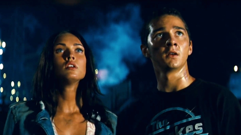 Megan Fox as Mikaela and Shia LaBeouf as Sam looking up at something in Transformers
