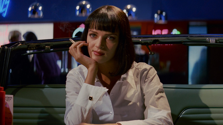 Uma Thurman as Mia sitting at a diner in Pulp Fiction.