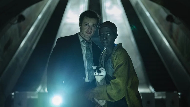 Eric (Joseph Quinn) with Samira (Lupita Nyong'o) holding a cat in A Quiet Place: Day One
