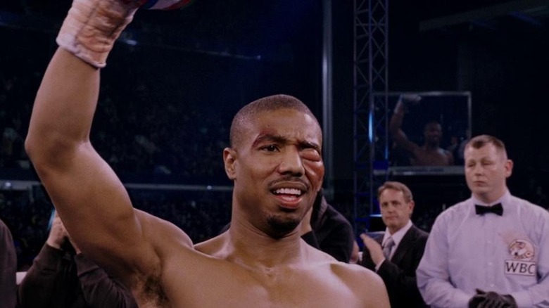Adonis Creed (Michael B. Jordan) with his fist raised triumphantly in Creed