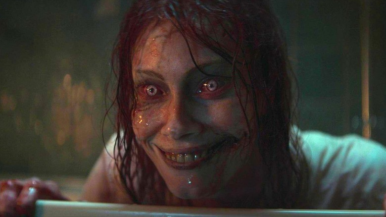 Ellie (Alyssa Sutherland) as a Deadite appearing from the tub in Evil Dead Rise