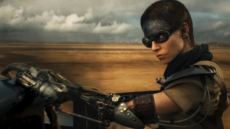 Furiosa (Anya Taylor-Joy) riding a hot rod in Furiosa: A Mad Max Saga