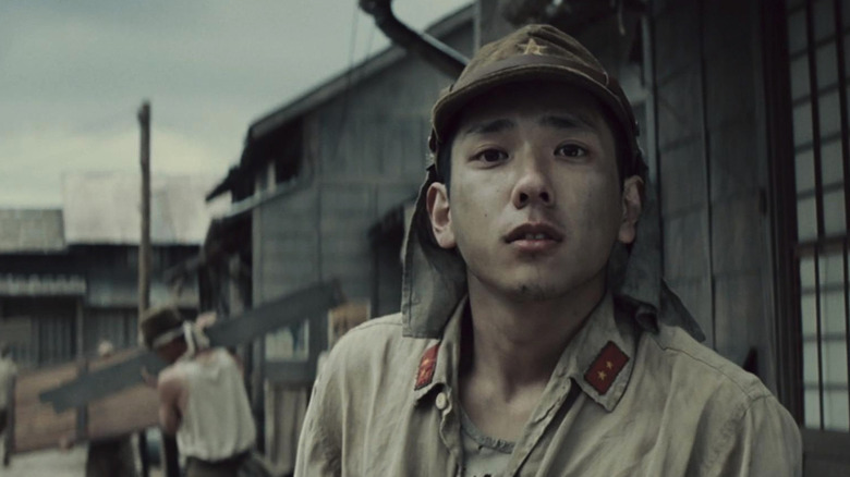 Kazunari Ninomiya in Letters from Iwo Jim as Private First Class Saigo, standing amid the battlements and looking concerned