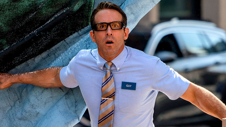 Ryan Reynolds as Guy, looking scared in glasses in Free Guy