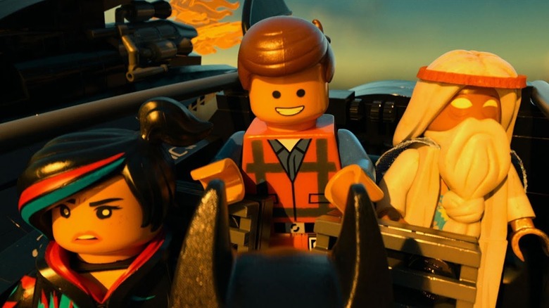 Lucy, Emmet, and Vitruvius riding in the Batwing in The Lego Movie