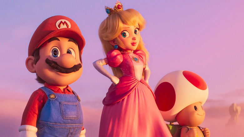 Mario, Peach, and Toad looking over the mushroom kingdom in The Super Mario Bros Movie