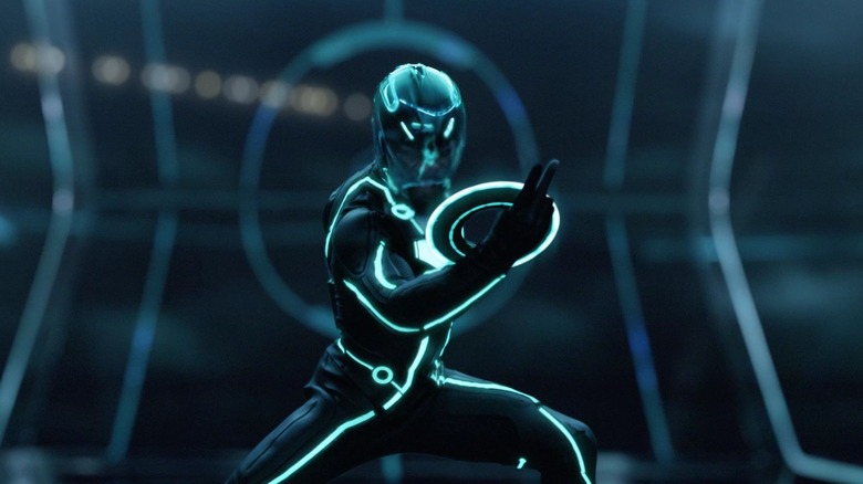 A soldier in neon lined clothing wields a light disk in Tron: Legacy