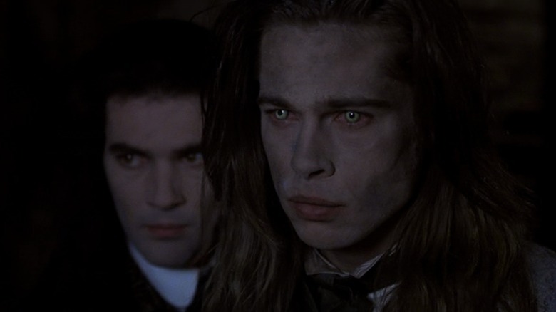 Antonio Banderas as Armand standing behind Brad Pitt as Louis de Pointe du Lac in Interview with the Vampire