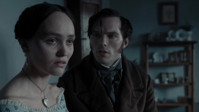 Lily-Rose Depp as Ellen Hutter standing next to Nicholas Hoult as Thomas Hutter in Nosferatu