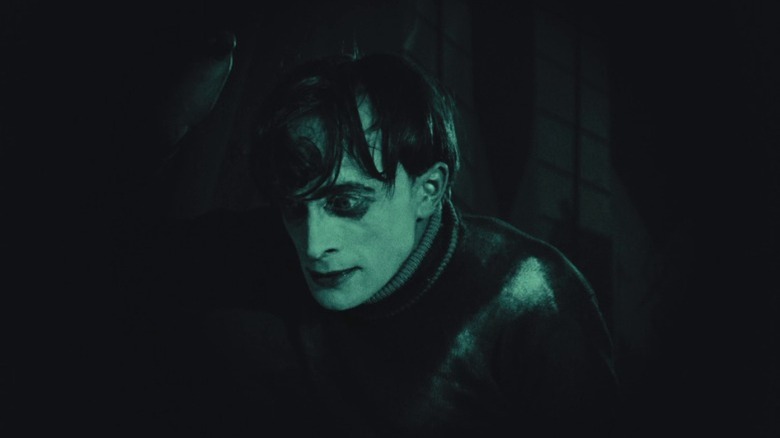 Conrad Veidt as Cesare staring forward with his head bowed while shrouded in darkness in The Cabinet of Dr. Caligari