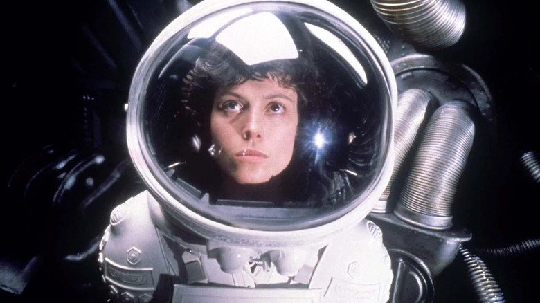 Sigourney Weaver as Ripley, staring up through an astronaut visor in Alien.
